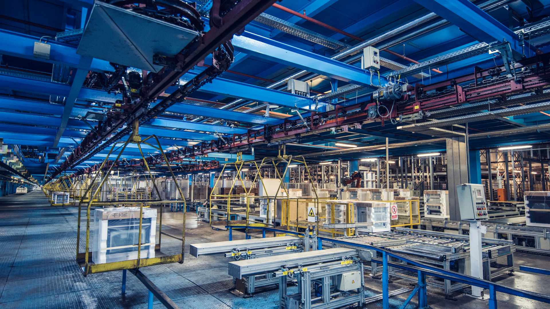 Interior view of a manufacturing facility with assembly lines and machinery in a structured layout.
